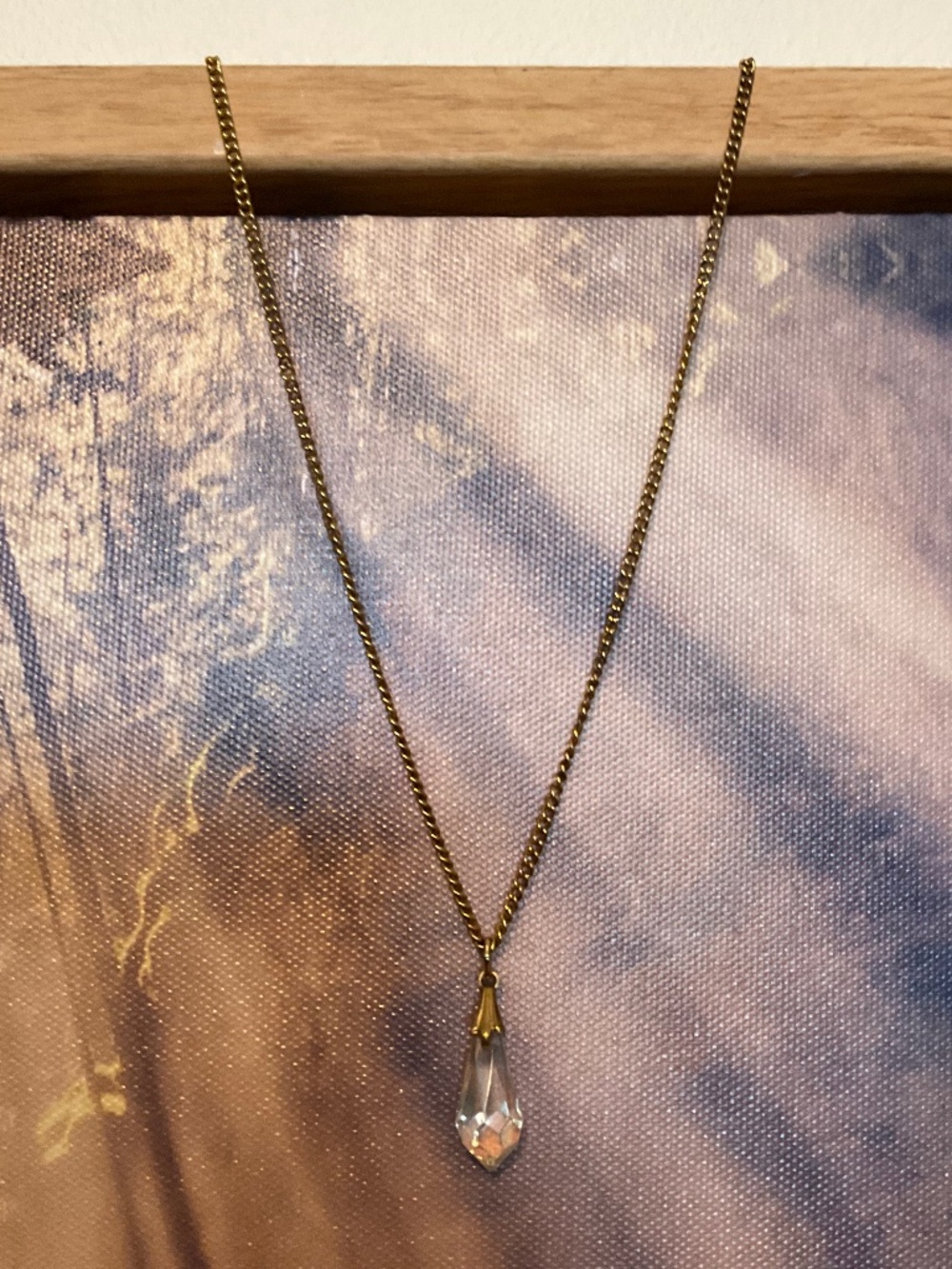 Gold toned chain necklace with a crystal teardrop pendant